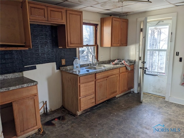 kitchen with a paneled ceiling and sink