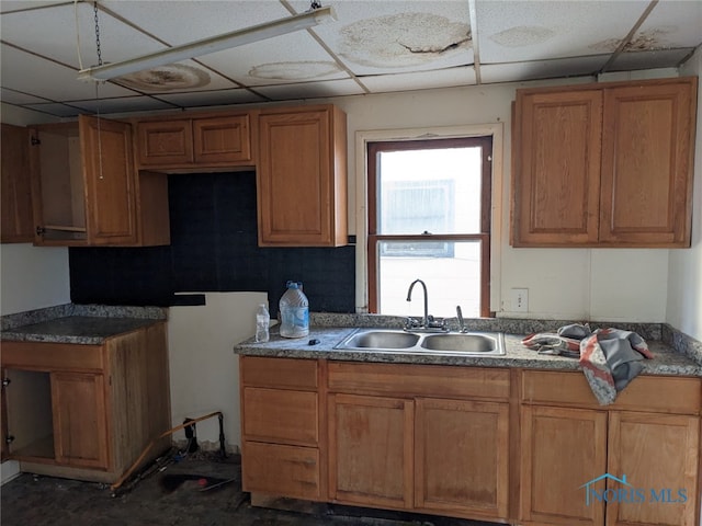 kitchen featuring a drop ceiling and sink