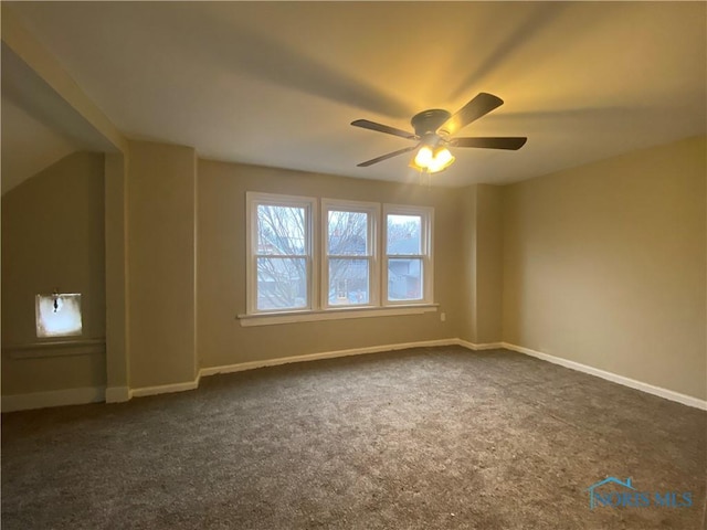 additional living space with ceiling fan and dark carpet