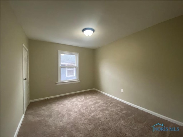 empty room featuring dark carpet