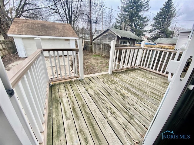 deck featuring a garage and an outdoor structure