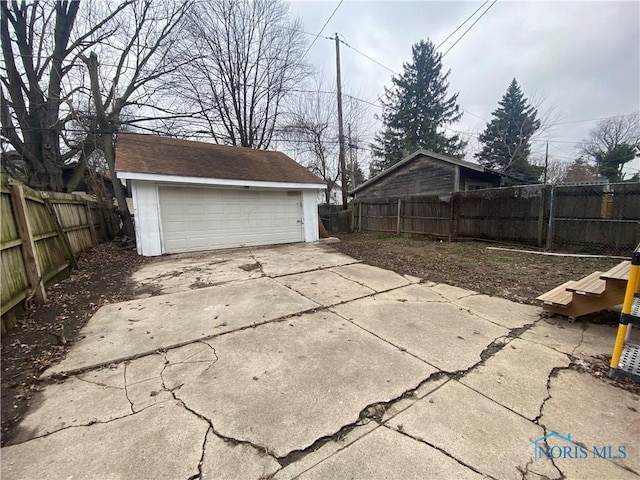 view of patio with a garage and an outdoor structure