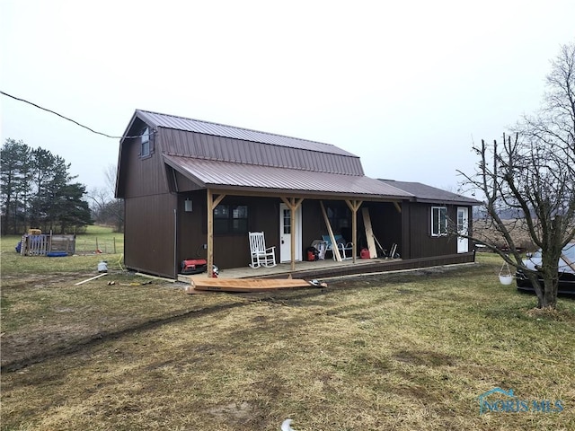 exterior space featuring a porch and a yard