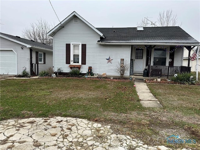 view of front facade with covered porch, a garage, and a front lawn