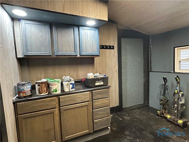 kitchen featuring wood walls