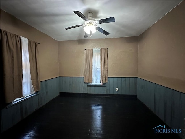 spare room featuring dark hardwood / wood-style floors and ceiling fan