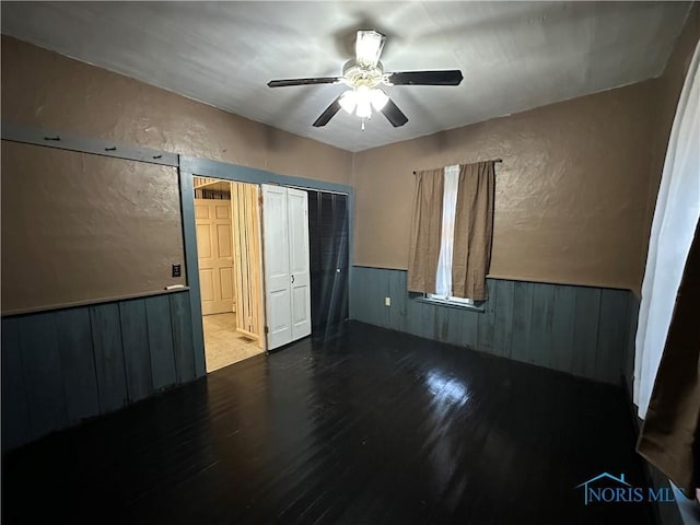 empty room with ceiling fan and wood-type flooring