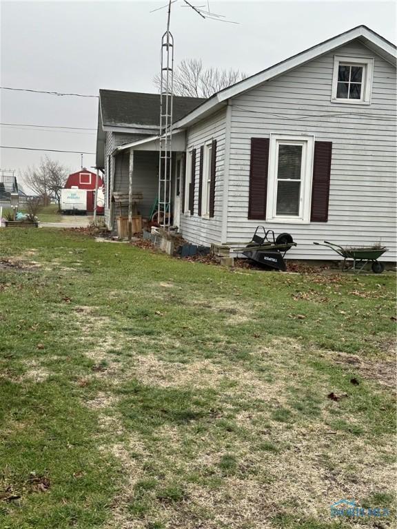 view of side of home with a lawn