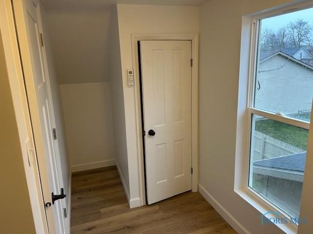 corridor with light hardwood / wood-style floors