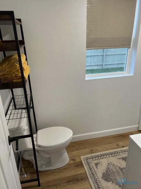 bathroom featuring hardwood / wood-style flooring, vanity, and toilet