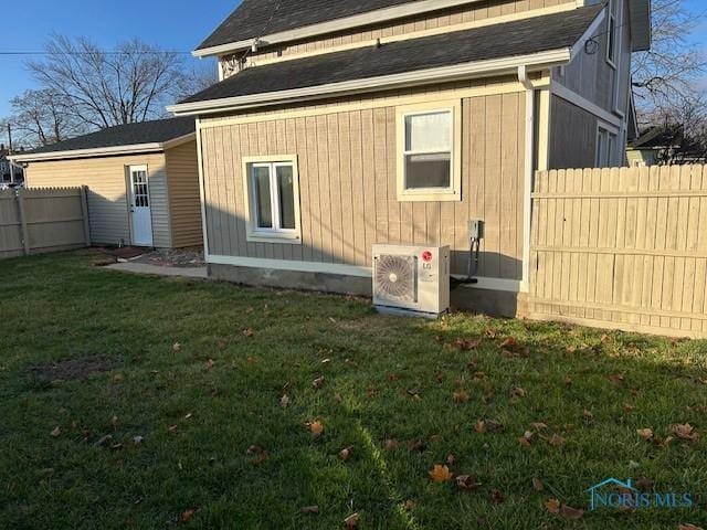 exterior space with ac unit and a yard