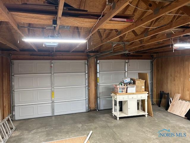 garage featuring wooden walls