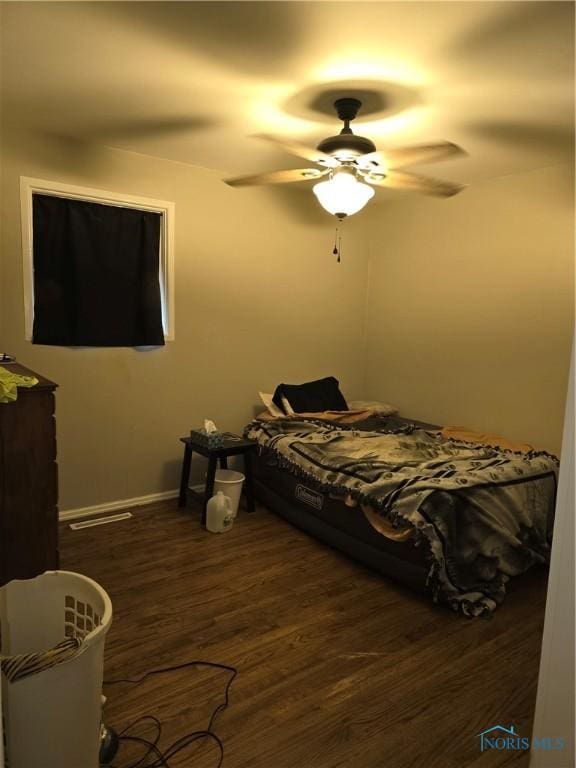 bedroom featuring ceiling fan and dark hardwood / wood-style floors