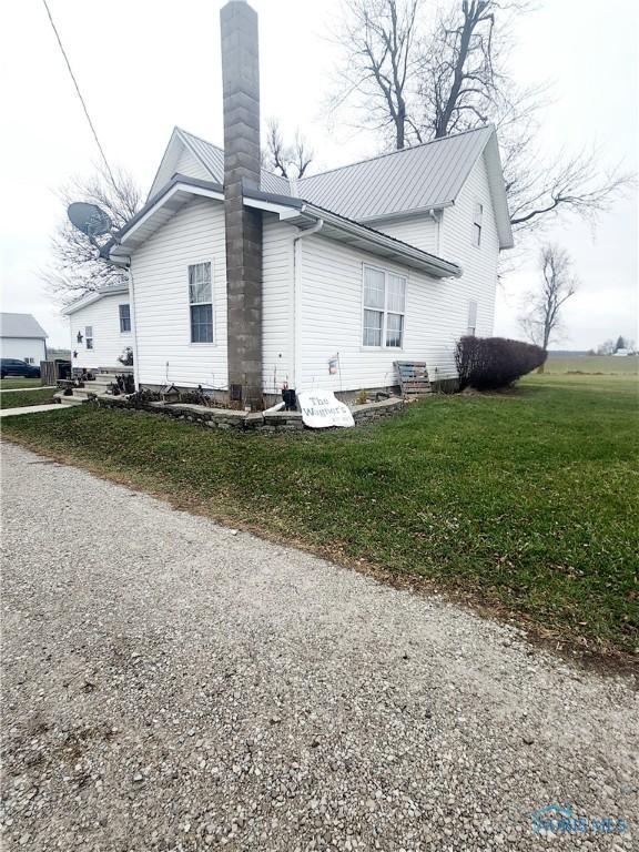 view of property exterior featuring a yard