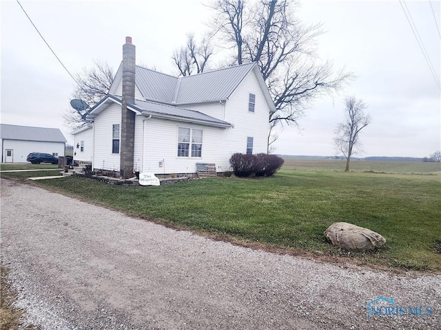 view of property exterior featuring a lawn