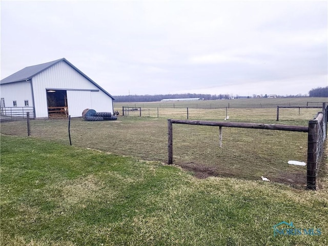 view of yard featuring a rural view and an outbuilding