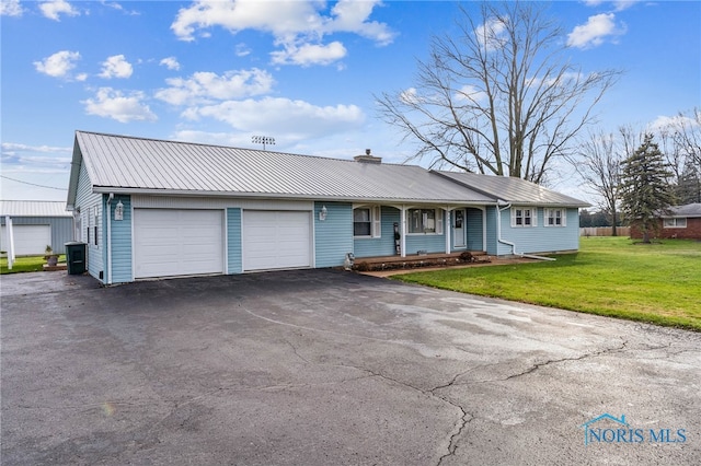 single story home with a front lawn, a porch, and a garage