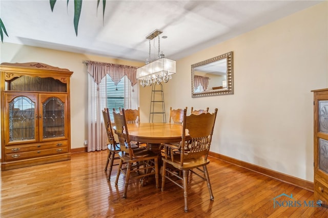 dining room featuring hardwood / wood-style flooring and a notable chandelier