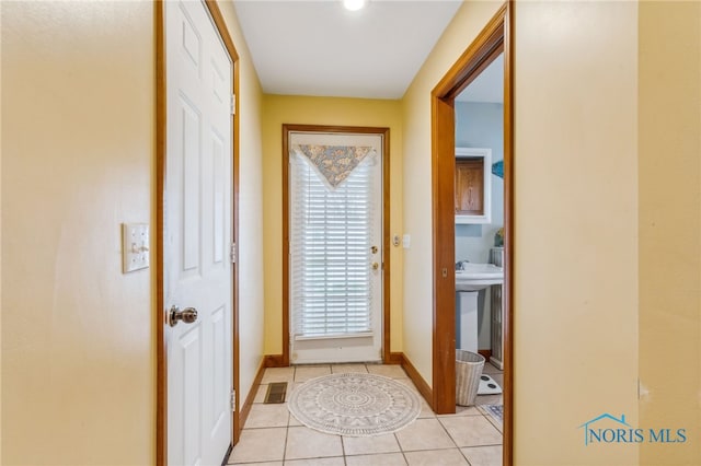 doorway to outside featuring light tile patterned floors