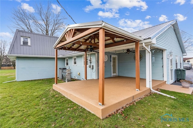 back of property featuring a yard, a patio, and ceiling fan