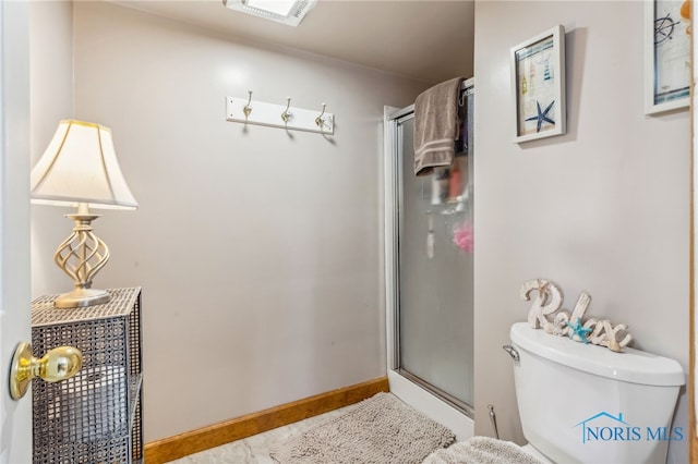 bathroom featuring toilet and an enclosed shower