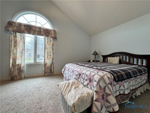 bedroom with carpet flooring and vaulted ceiling