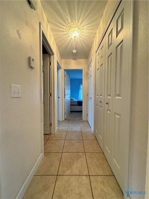 corridor featuring light tile patterned flooring