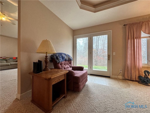 living area with plenty of natural light, ceiling fan, lofted ceiling, and light carpet