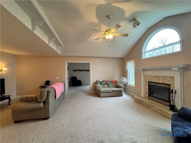 living room with carpet flooring, ceiling fan, lofted ceiling, and a fireplace