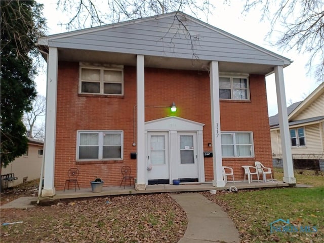 1719 W Bancroft St, Toledo, OH 43606 - view of front of house featuring covered porch and brick siding