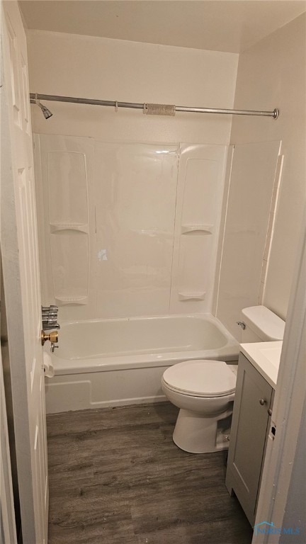 full bathroom featuring vanity, toilet, wood-type flooring, and bathtub / shower combination