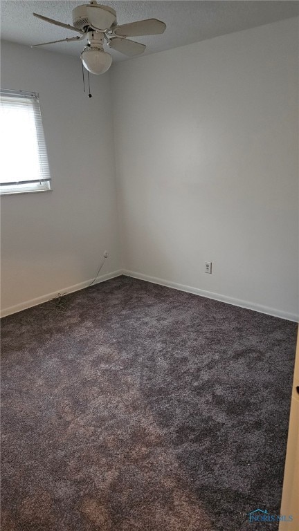 carpeted spare room with a textured ceiling and ceiling fan