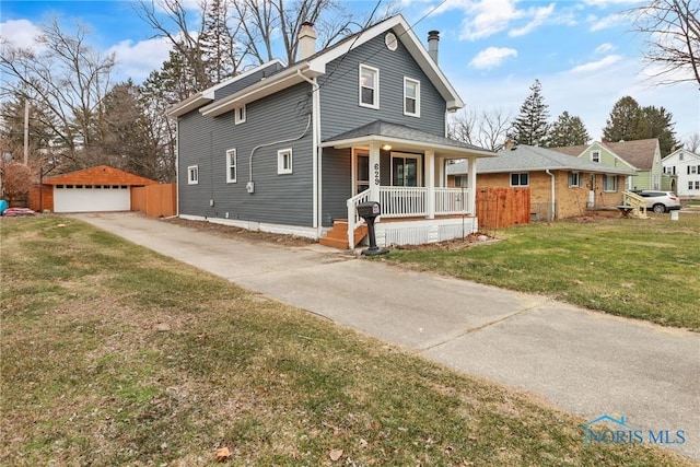 view of front facade featuring covered porch, a garage, an outbuilding, and a front yard