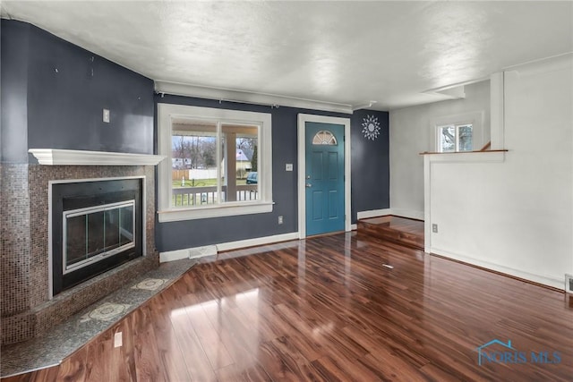 unfurnished living room with hardwood / wood-style flooring