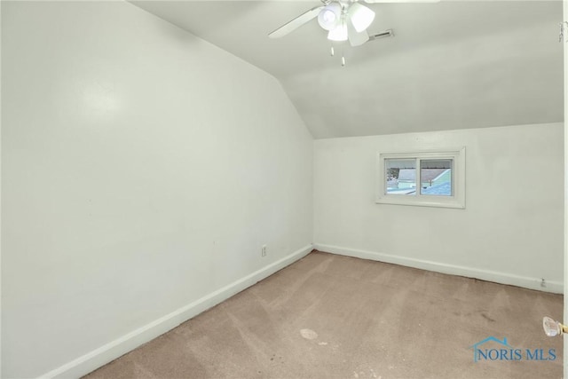 additional living space with ceiling fan, light colored carpet, and lofted ceiling