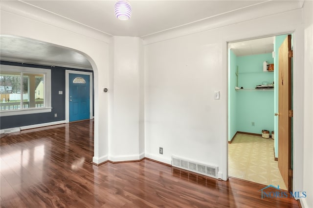 unfurnished room with hardwood / wood-style flooring and ornamental molding