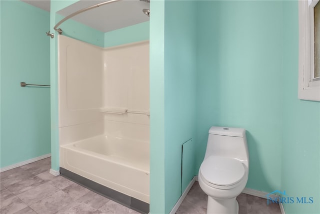 bathroom featuring shower / bathtub combination and toilet