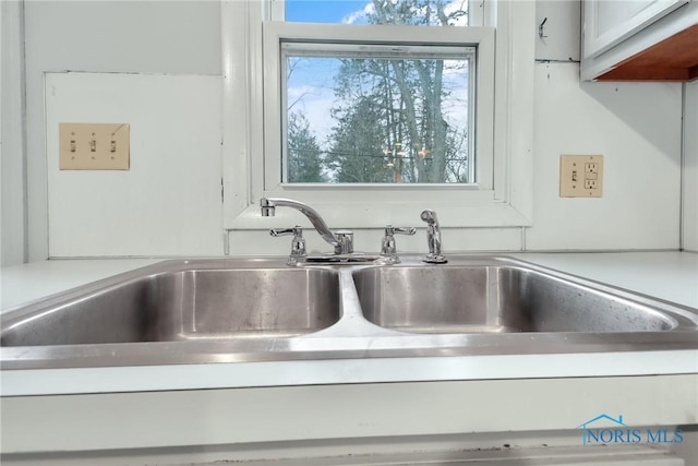 room details with white cabinetry and sink