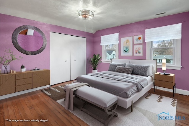 bedroom with hardwood / wood-style flooring and a closet