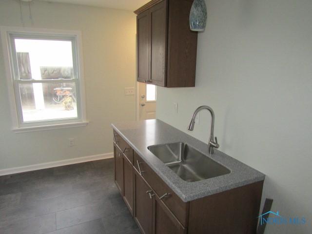 kitchen featuring dark brown cabinets and sink