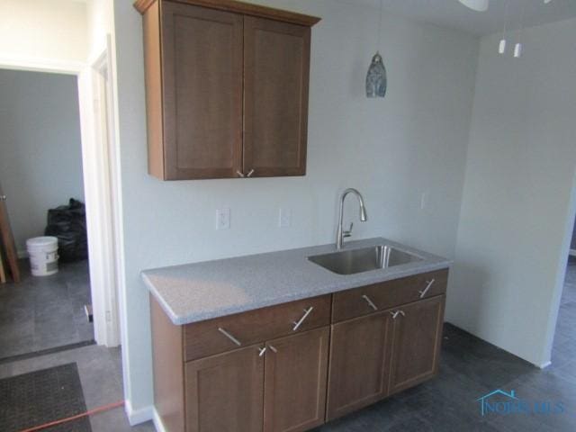 kitchen with sink and dark tile patterned flooring