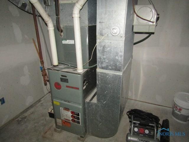 utility room featuring heating unit