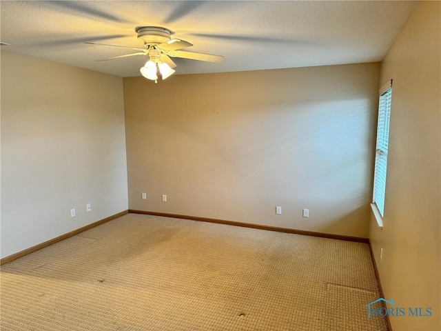 carpeted spare room with ceiling fan and a healthy amount of sunlight