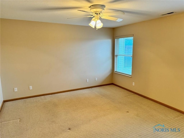 carpeted empty room featuring ceiling fan