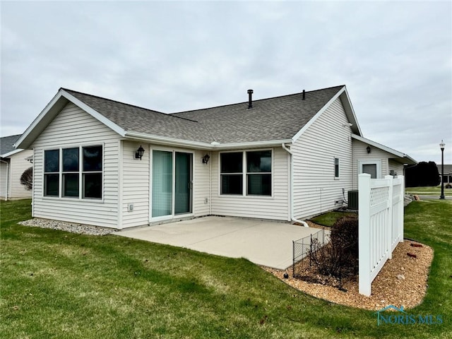 back of property featuring a lawn, a patio area, and central air condition unit