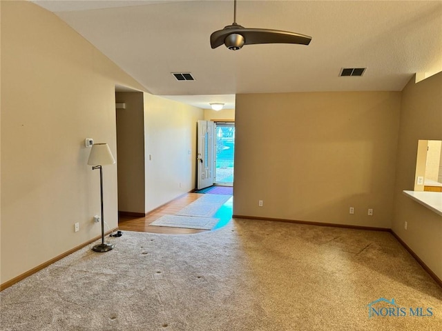 unfurnished room with light carpet, ceiling fan, and lofted ceiling