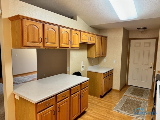 kitchen featuring light wood-type flooring and a textured ceiling