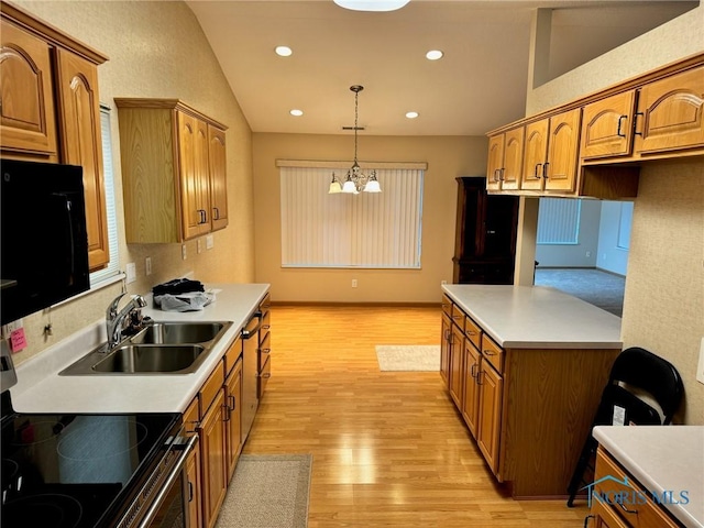 kitchen featuring sink, decorative light fixtures, light hardwood / wood-style flooring, an inviting chandelier, and stainless steel range oven