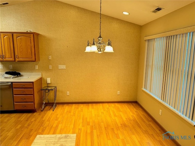 kitchen with dishwasher, decorative light fixtures, lofted ceiling, and light wood-type flooring