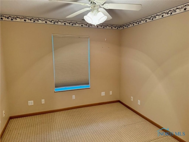 carpeted empty room featuring ceiling fan